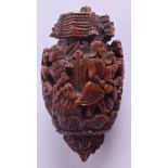 AN 18TH/19TH CENTURY CARVED COQUILLA NUT TREEN SNUFF BOX carved with figures in various pursuits. 7