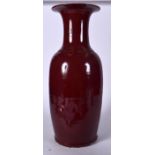 A LARGE CHINESE QING DYNASTY OX BLOOD GLAZED PORCELAIN VASE, formed with a flared rim. 54.5 cm high