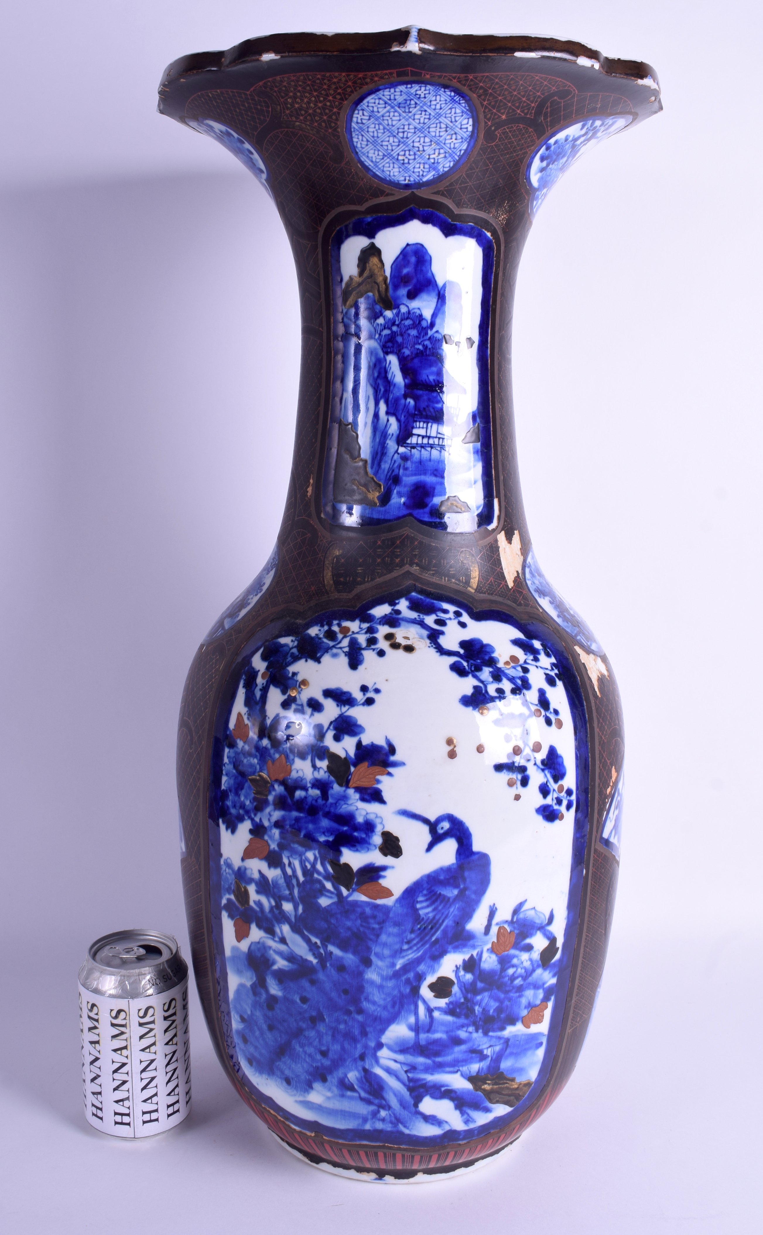 A LARGE 19TH CENTURY JAPANESE MEIJI PERIOD BLUE AND WHITE VASE lacquered with black and red motifs.