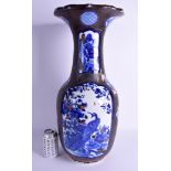 A LARGE 19TH CENTURY JAPANESE MEIJI PERIOD BLUE AND WHITE VASE lacquered with black and red motifs.