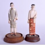 A PAIR OF 18TH CENTURY INDIAN ASIAN PAINTED IVORY BURMESE FIGURES modelled upon hardwood bases. 13