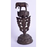 A 19TH CENTURY TIBETAN COPPER ALLOY BUDDHISTIC ORNAMENT modelled with an elephant upon a lotus flow