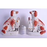 A VERY LARGE PAIR OF ANTIQUE STAFFORDSHIRE SPANIELS modelled with attendants. 34 cm x 21 cm.