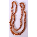 AN EARLY/MID 20TH CENTURY AMBER BEAD NECKLACE, formed with facetted beads. 80 cm long and weight 29