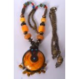 AN AMBER TYPE TIBETAN NECKLACE, inset with turquoise coloured beads and formed with metal floral in