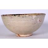 A PERSIAN POTTERY BOWL, decorated with a stylised bird. 19 cm wide.