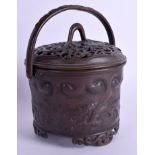 AN EARLY 20TH CENTURY CHINESE SWING HANDLED BRONZE CENSER AND COVER decorated with chilong dragons.