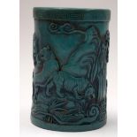A CHINESE TURQUOISE COLOURED BRUSH POT OR BITONG, carved in relief with tigers in a landscape. 12.5