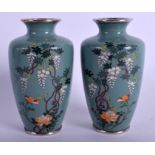 A PAIR OF EARLY 20TH CENTURY JAPANESE MEIJI PERIOD CLOISONNE ENAMEL VASES decorated with foliage an