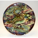 A PORTUGUESE PALISSY WARE PORCELAIN WALL PLATE BY JOSE A CUNHA, decorated with fish and an eel. 24.