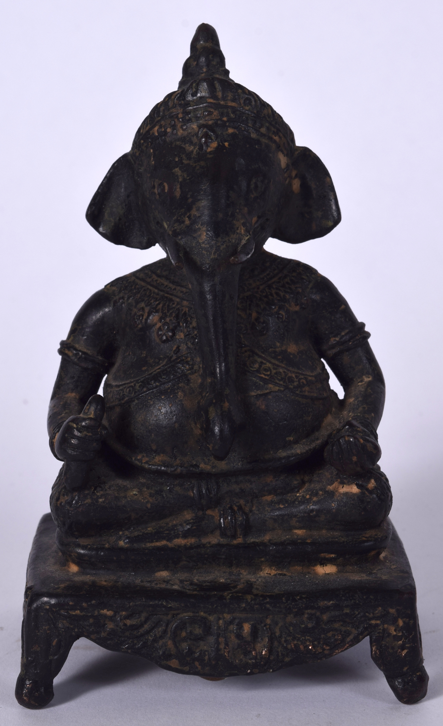 AN INDIAN BRONZE STATUE IN THE FORM OF GANESHA, modelled holding ritual objects upon a rectangular