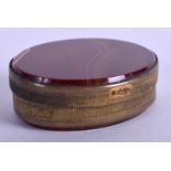 A VICTORIAN AGATE AND BRASS PILL BOX. 5 cm wide.