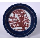 A CHINESE QING DYNASTY BLUE GROUND PORCELAIN DISH BEARING XUANDE MARKS, painted with iron red folia