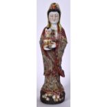 A LARGE CHINESE PORCELAIN FIGURINE IN THE FORM OF GUANYIN, formed standing holding a child in folia