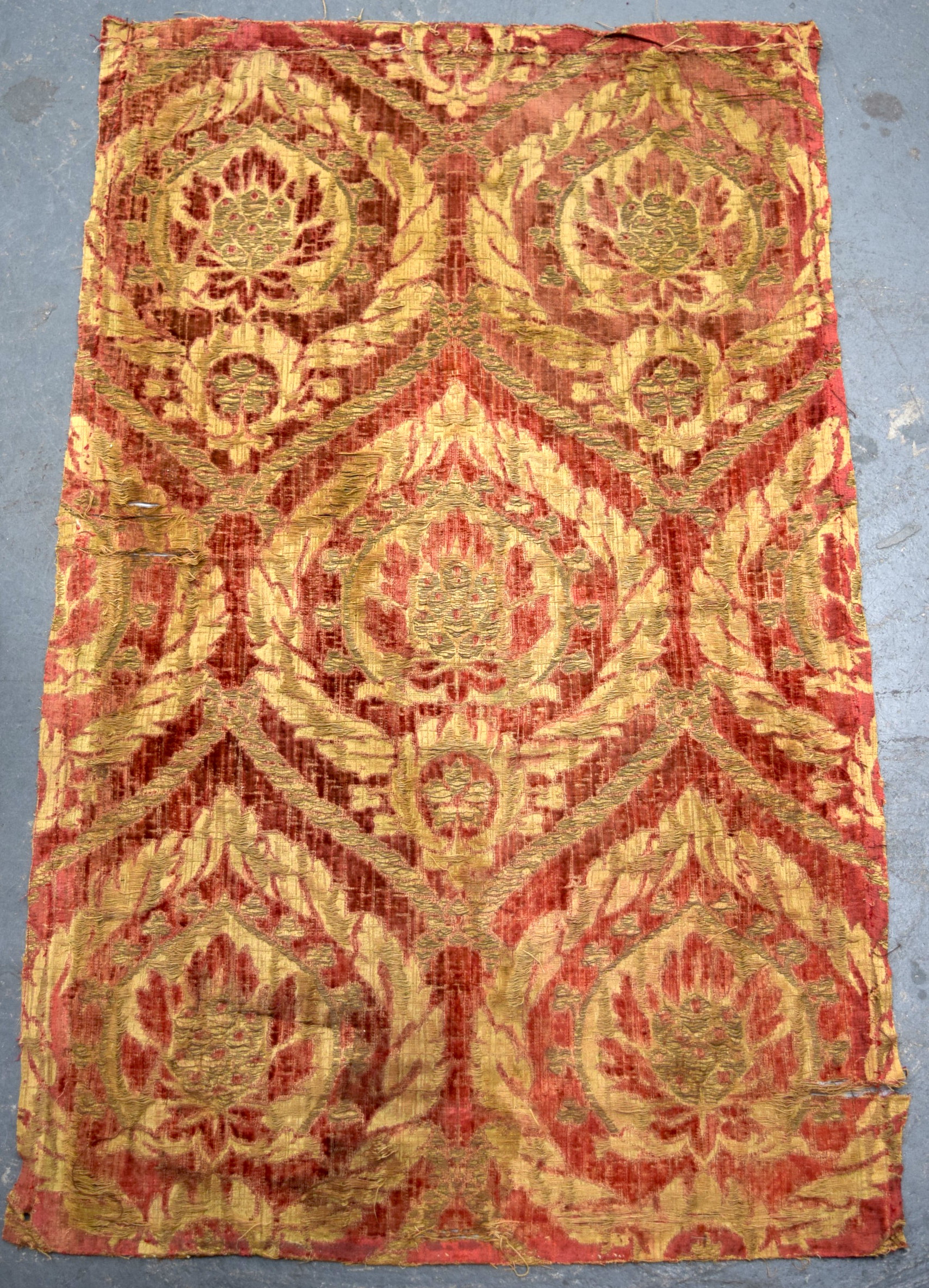 A RED GROUND OTTOMAN ISLAMIC TEXTILE, decorated with bold foliage. 89 cm x 53.5 cm.
