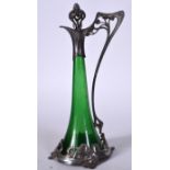 AN ART NOUVEAU GREEN GLASS AND WHITE METAL MOUNTED DECANTER, decorated with females in an embrace.