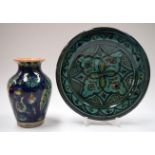 AN EARLY 20TH CENTURY ISLAMIC POTTERY VASE, together with a dish. Vase 17 cm high. (2)