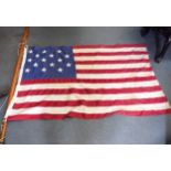 A VINTAGE AMERICAN FIFTEEN STAR FLAG OR STAR SPANGLED BANNER, with associated wooden pole. 93 cm x