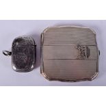 AN ANTIQUE SILVER VESTA CASE together with a Scottie dog compact. (2)