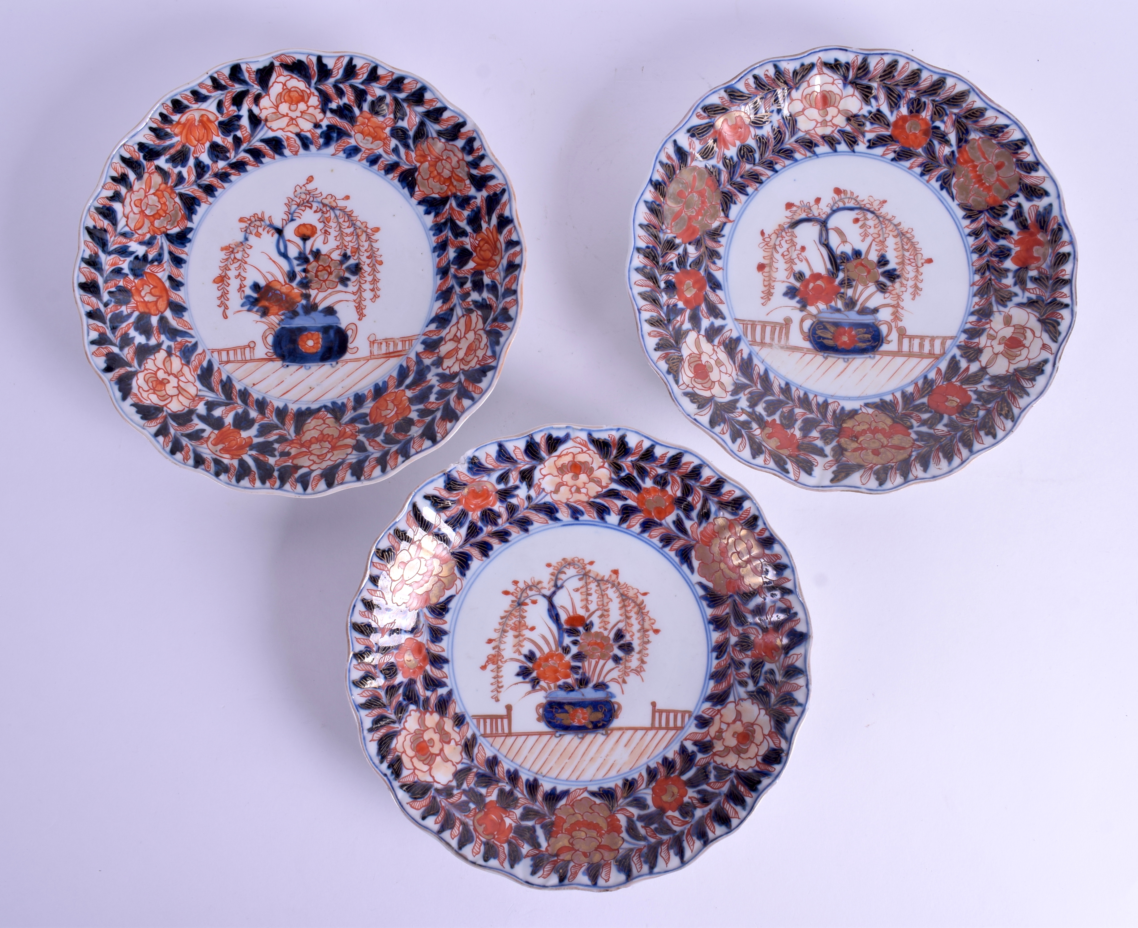 A SET OF THREE 18TH CENTURY JAPANESE IMARI SCALLOPED DISHES painted with foliage. 23 cm diameter. (