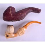 AN ANTIQUE CARVED MEERSCHAUM AND AMBER PIPE in the form of a hand. 16 cm long.