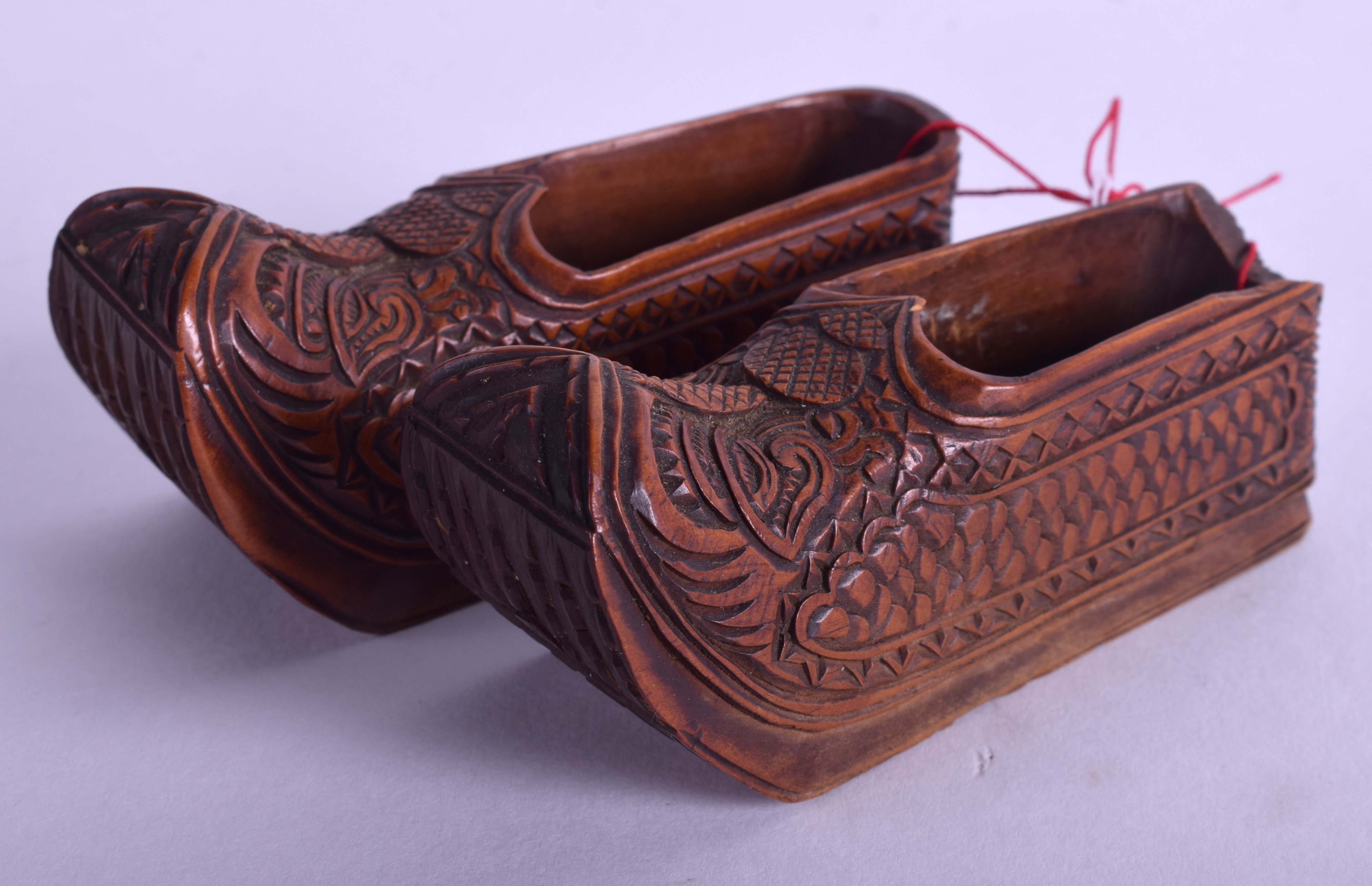 A PAIR OF 19TH CENTURY CONTINENTAL FRUITWOOD CLOGS carved with motifs. 8 cm long.