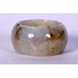 A CHINESE CARVED JADE RING, of plain form. 2.9 cm wide.