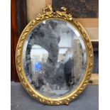 A GILDED OVAL MIRROR, decorated with floral wreaths. 48 cm x 36 cm.