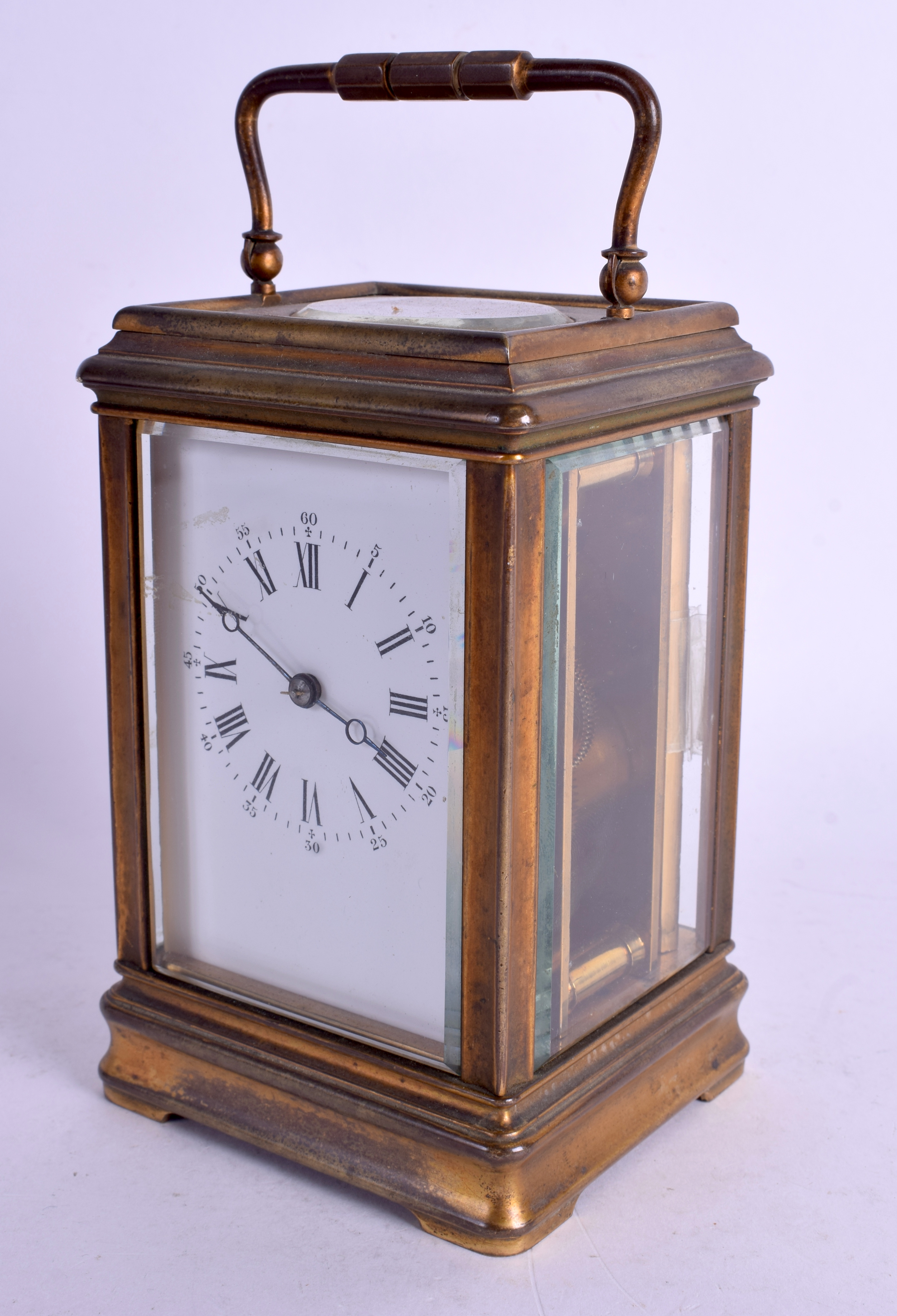 AN ANTIQUE FRENCH BRASS CARRIAGE CLOCK with roman numeral & numerical dial. 17.5 cm high inc handle