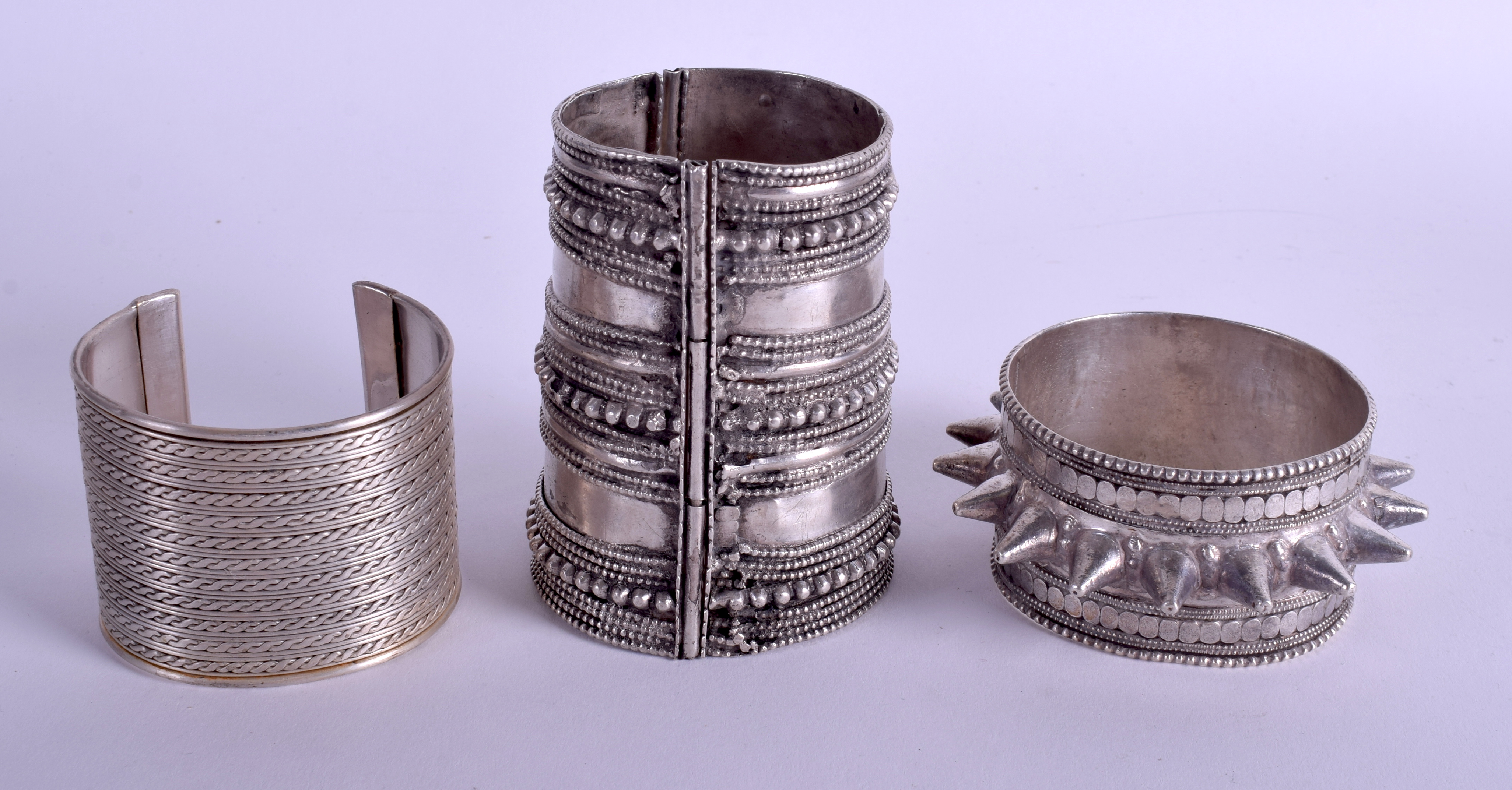 THREE MIDDLE EASTERN TRIBAL SILVER BRACELETS in various forms. 12.8 oz. Largest 9 cm long. (3)