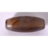 A CHINESE CARVED AGATE ZHU BEAD OR DZI BEAD, formed with swirling body. 3 cm long.