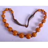 AN EARLY 20TH CENTURY CHINESE CARVED HORN AND AMBER TYPE NECKLACE. 131 grams. 70 cm long.