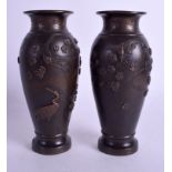 A PAIR OF 19TH CENTURY JAPANESE MEIJI PERIOD BRONZE VASES decorated with birds amongst foliage. 15