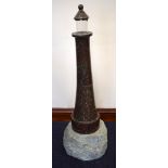 A VERY LARGE RARE CORNISH SERPENTINE LIGHTHOUSE upon a stone base. 95 cm x 30 cm.