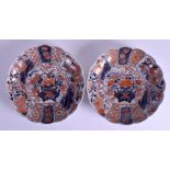A PAIR OF 18TH CENTURY JAPANESE IMARI SCALLOPED DISHES painted with flowers. 22 cm wide.