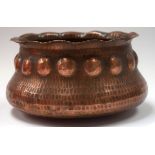 AN ARTS & CRAFTS HAMMERED COPPER BOWL, formed with wavy rim and bold beaded banding. 22 cm wide.