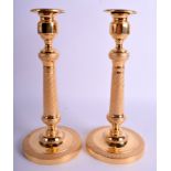 A PAIR OF CLASSICAL YELLOW METAL CANDLESTICKS. 26 cm high.