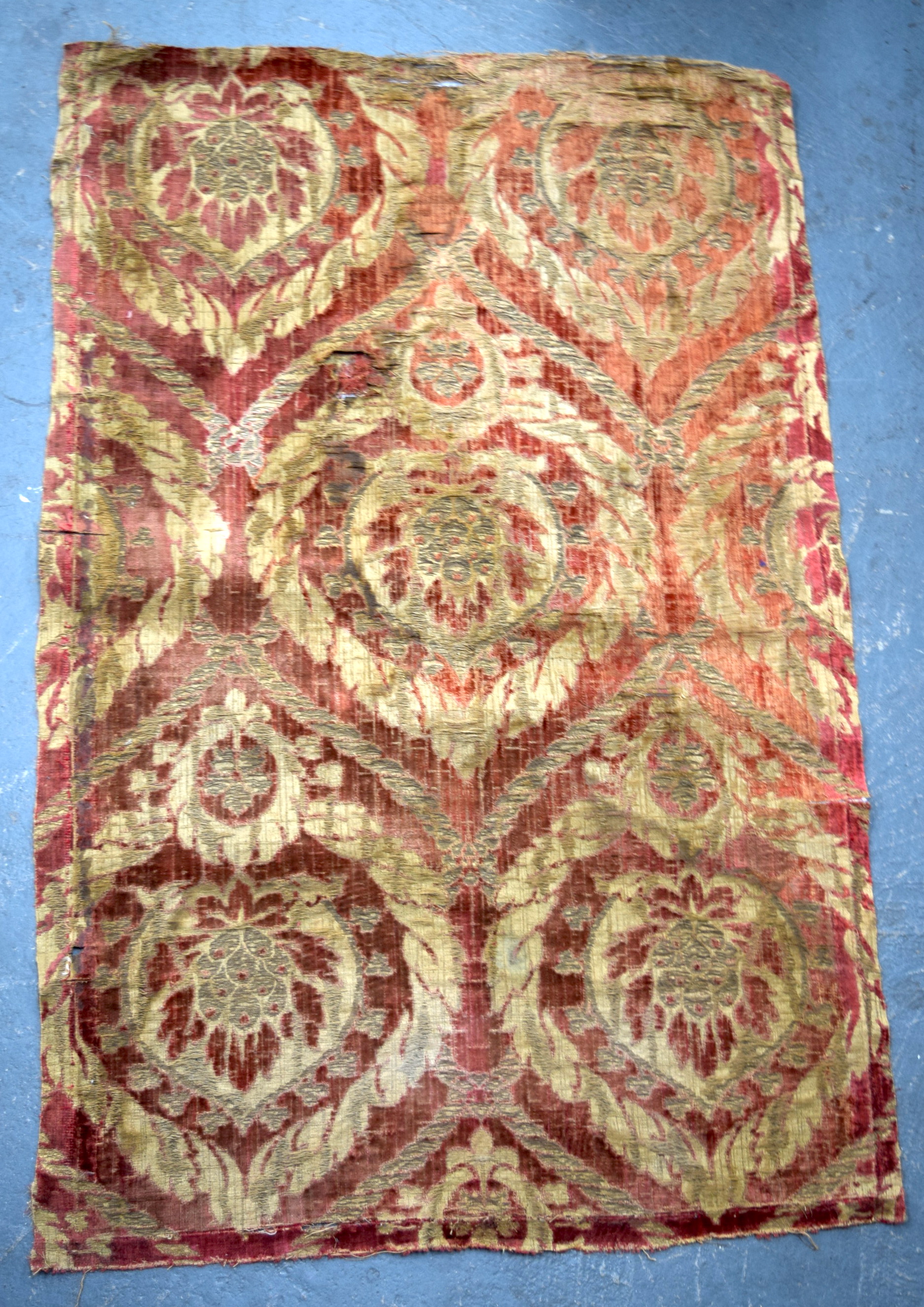 A RED GROUND OTTOMAN ISLAMIC TEXTILE, decorated with bold foliage. 84 cm x 55 cm.