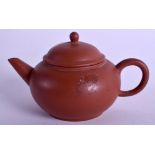 AN EARLY 20TH CENTURY CHINESE YIXING POTTERY TEAPOT AND COVER of plain form. 9 cm wide.