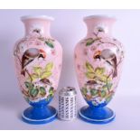 A LARGE PAIR OF LATE VICTORIAN OPALINE GLASS VASES painted with birds. 38 cm high.