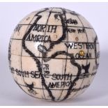 A CARVED BONE GLOBE COMPASS, etched with various illustrations. 7 cm x 7 cm.