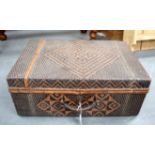 AN EASTERN WICKER SUITCASE, decorated with geometric motifs. 54.5 cm wide.