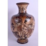 A 19TH CENTURY MARTIN BROTHERS STONEWARE VASE decorated with leaves, insects and foliage. 25.5 cm h