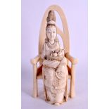 A 19TH CENTURY JAPANESE MEIJI PERIOD CARVED IVORY OKIMONO modelled as a female upon a throne. 18 cm