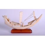 A 1930S JAPANESE MEIJI PEIROD CARVED IVORY AND AMBER BOAT. 18 cm x 12 cm.