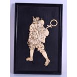 A 19TH CENTURY JAPANESE MEIJI PERIOD CARVED IVORY PANEL depicting a male with a monkey upon his bac