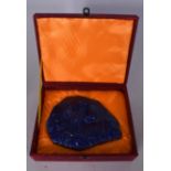 A LARGE LAPIS LAZULI PLAQUE, boldly carved with the face of a lion, boxed. 19.5 cm x 14.5 cm.