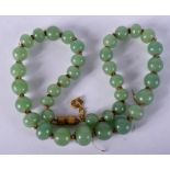 AN EARLY 20TH CENTURY CHINESE JADE NECKLACE. 40 cm long.