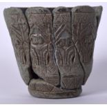 AN EARLY EASTERN CARVED HARDSTONE BEAKER VASE, decorated with foliage. 9 cm x 9.75 cm.
