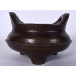 A CHINESE QING DYANSTY BRONZE CENSER, formed with high loop handles, signed. 11 cm x 15 cm.